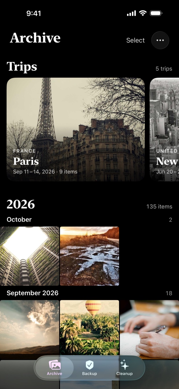 The Archive tab: trips to Paris and New York City as cards above the photos, which are grouped by month